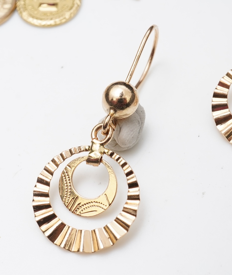 A gold necklace and pair of earrings